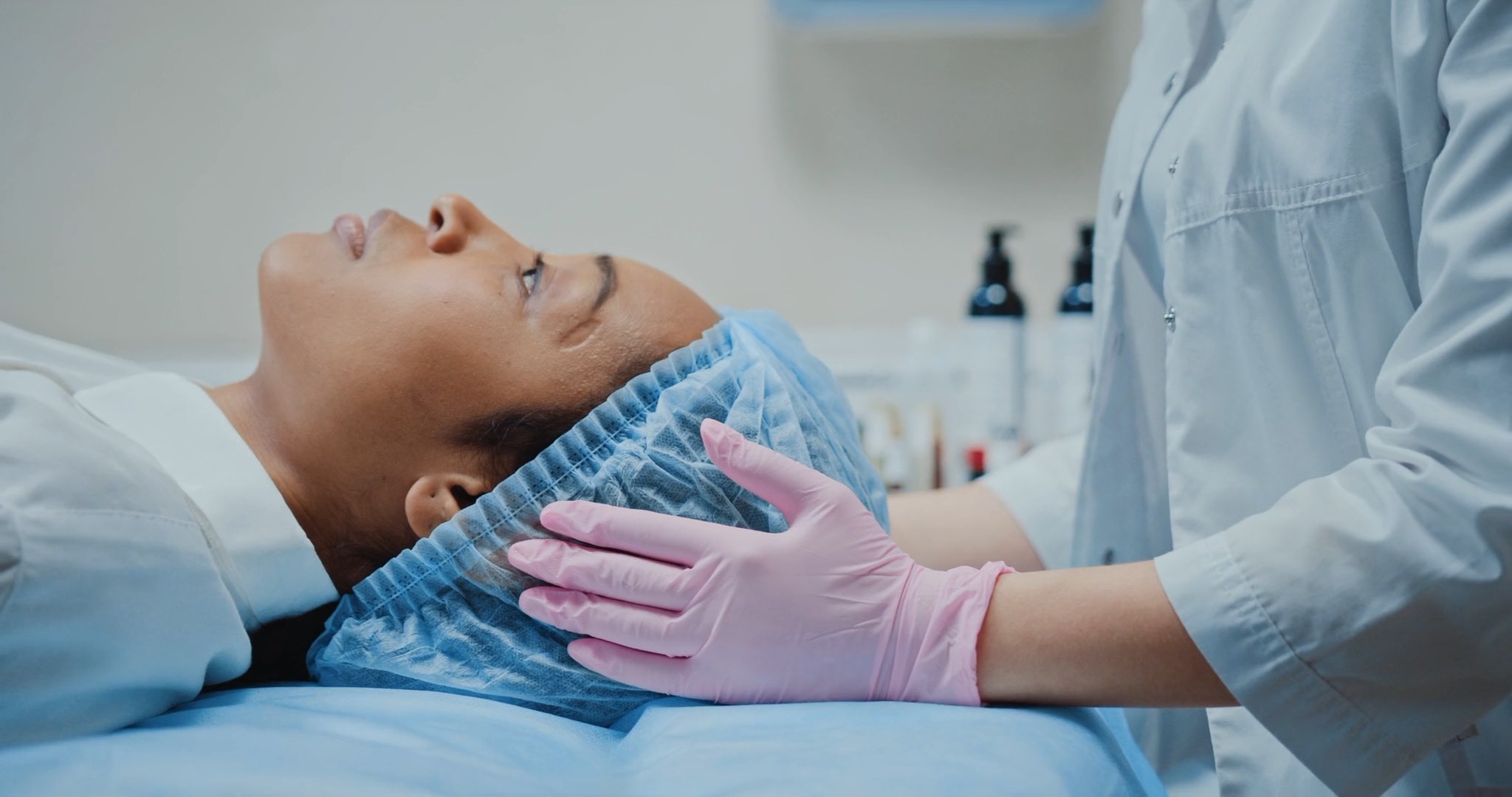 A clinician speaks with a woman during a cosmetic care consultation
